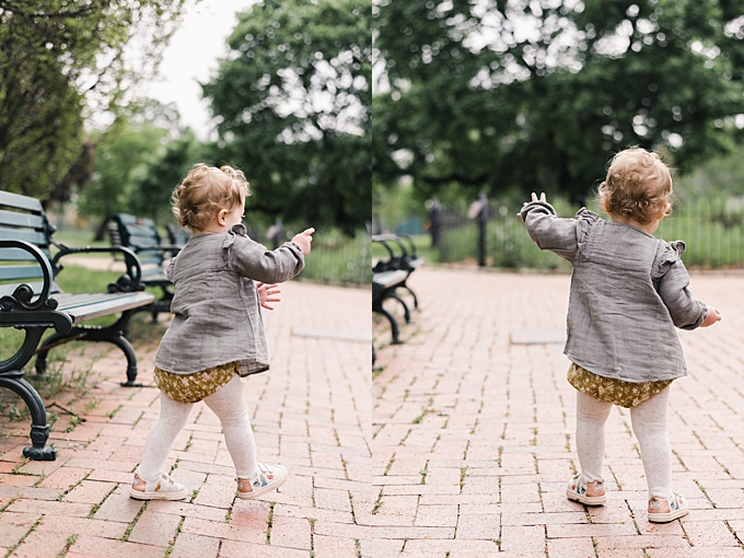 baby photographer columbus ohio baby girl dances on brick walkway