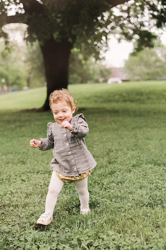baby photographer columbus ohio 18 month old girl runs in the grass wearing jamie kay