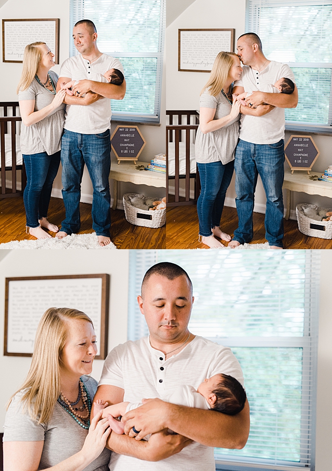columbus newborn photographer family snuggles while holding new baby daughter in nursery