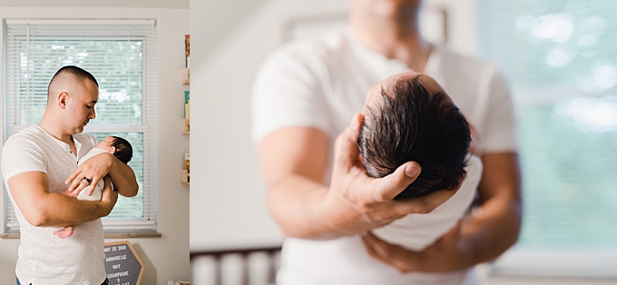 columbus newborn photographer dad holds daughter with dark brown hair