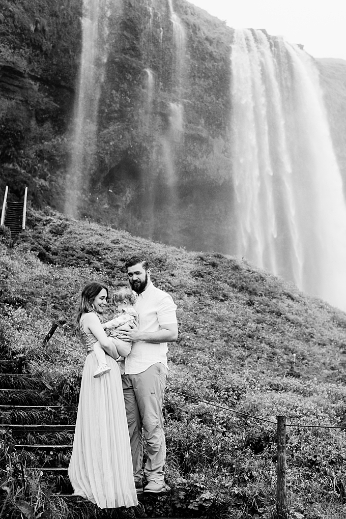 family photographer snuggles in front of waterfall in iceland 