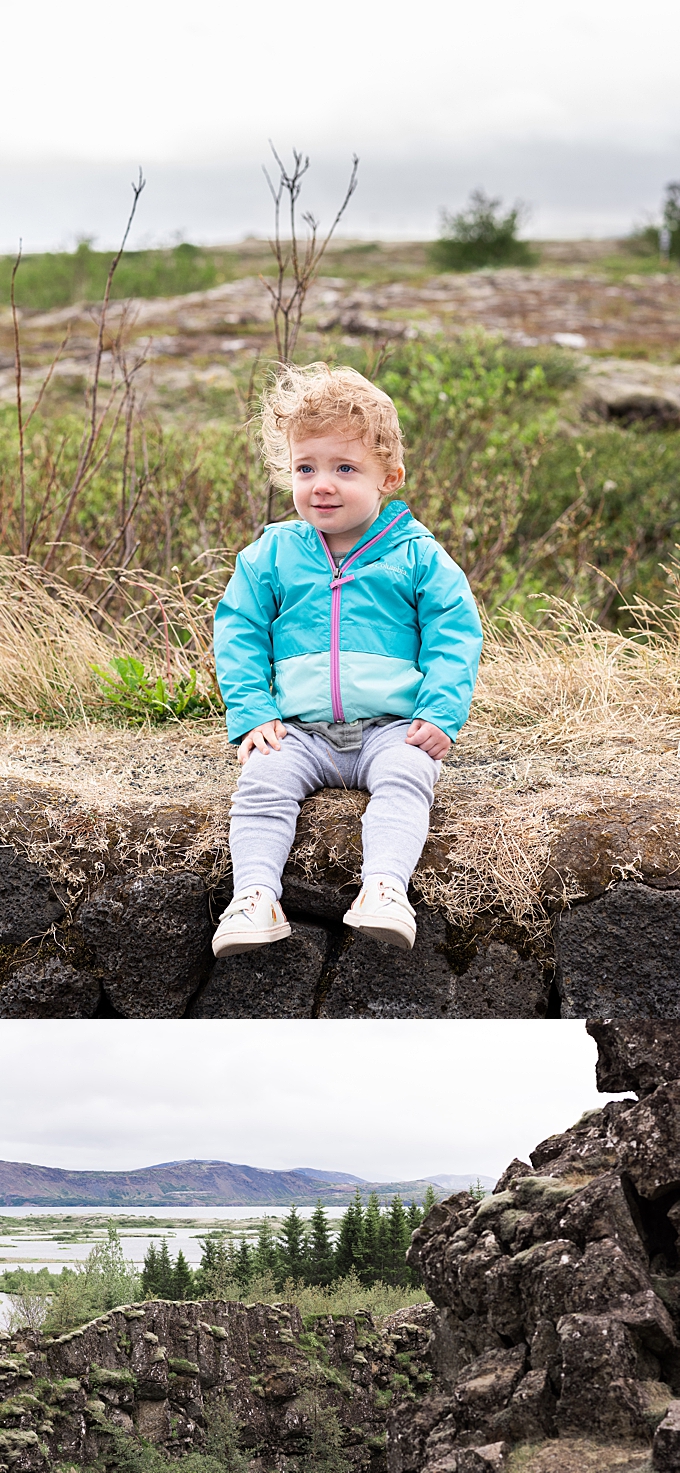 toddler sits on rock wall in iceland lifestyle family photography