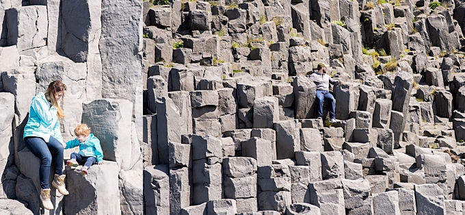 family sits on basalt formations at Reynisfjara 