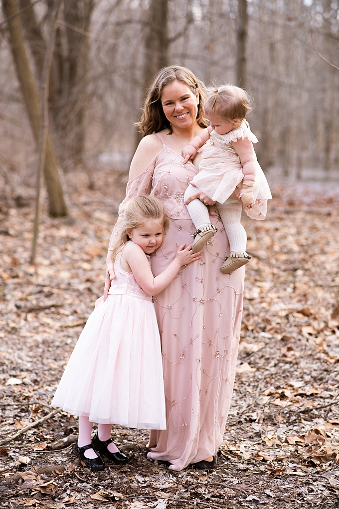 columbus family photographer mom and two daughters hug in the forest
