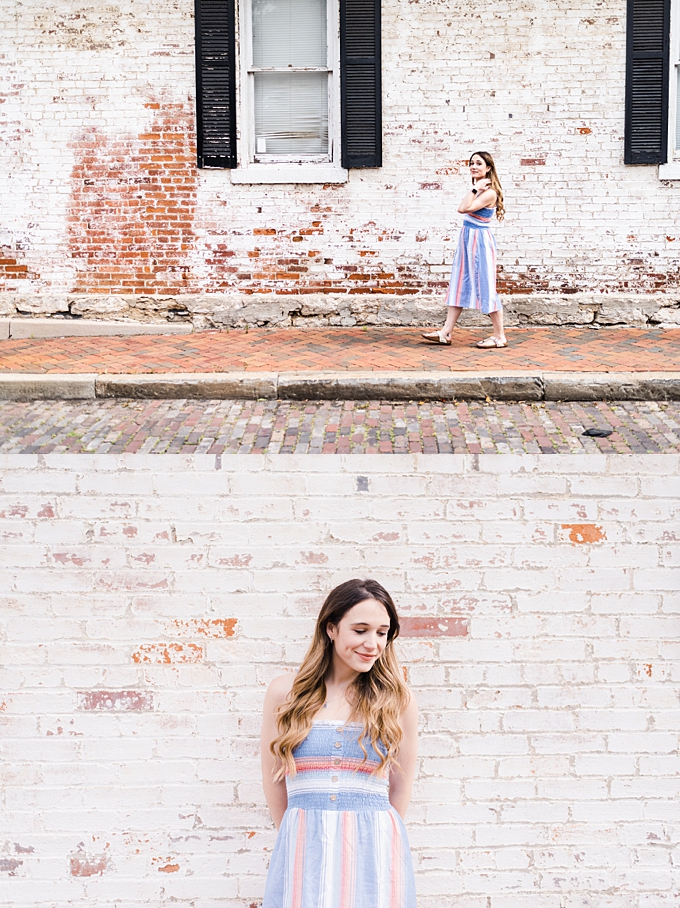 columbus ohio photographers woman walks next to old white brick building