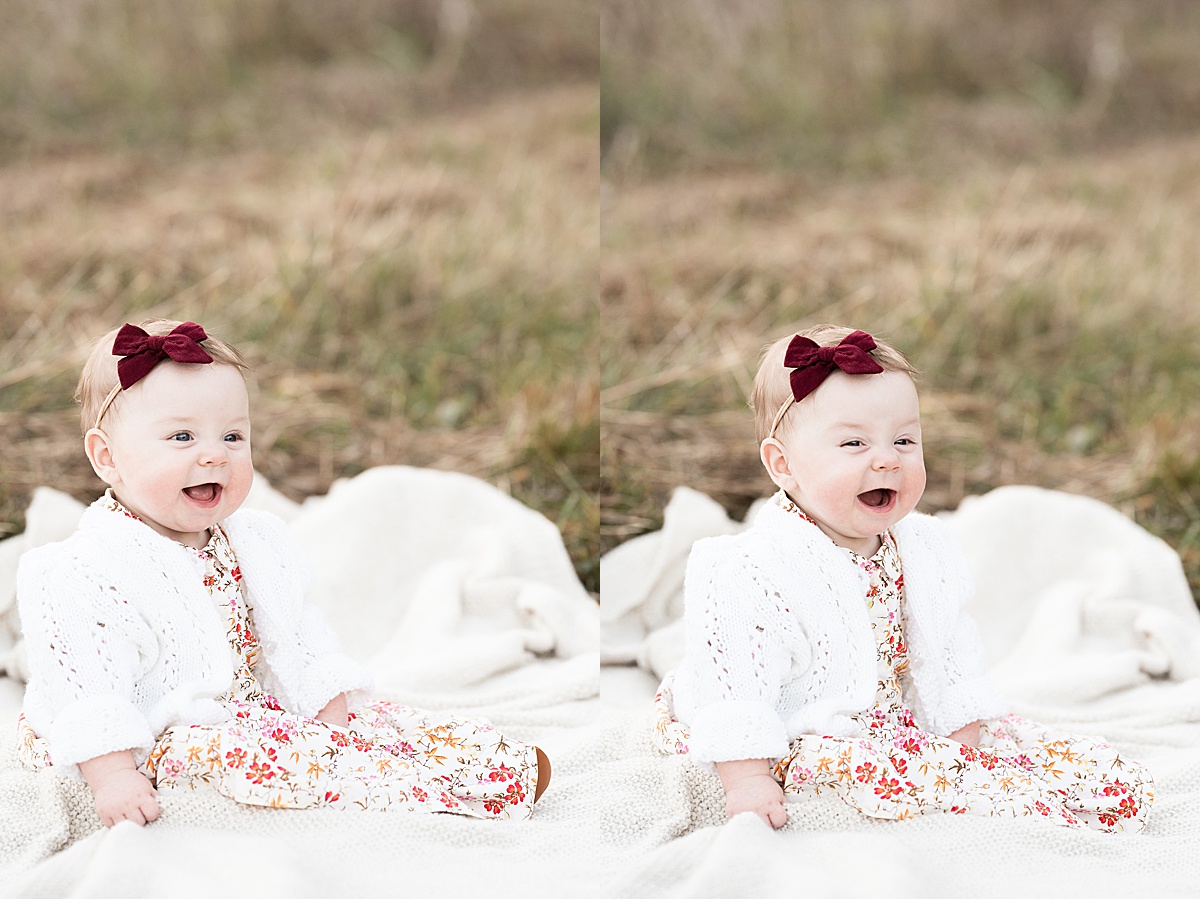 columbus lifestyle family photographer baby girl sits and laughs outside at sunset