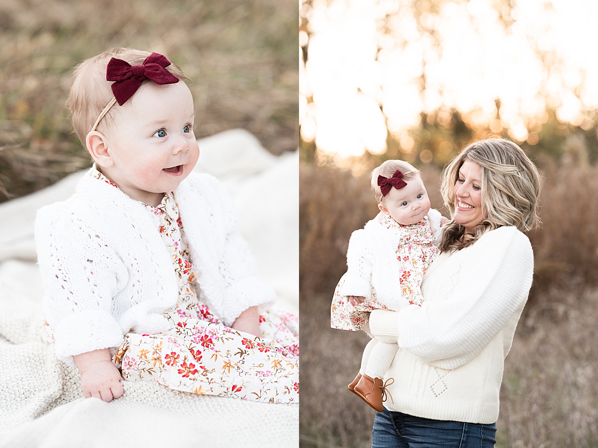 columbus lifestyle family photographer mom holds six month old with red bow in field at sunset