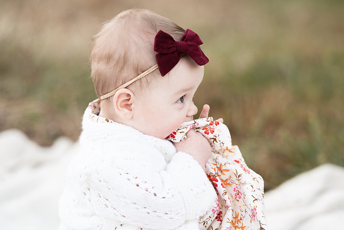 columbus lifestyle family photographer baby girl eats her dress outside 