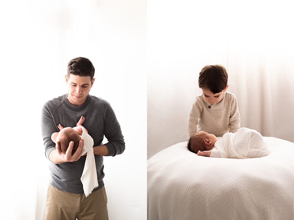 photography newborn dad holds new son in white