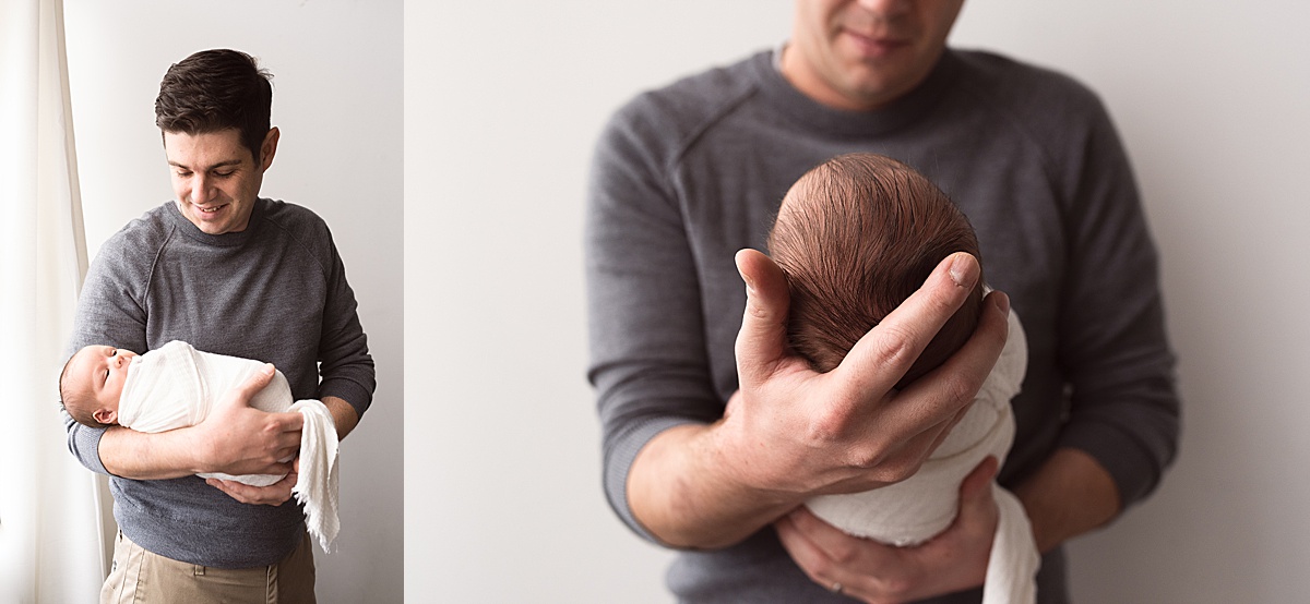 photography newborn details of baby boys long black hair in dad's arms