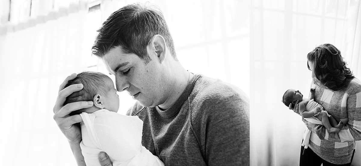 photography newborn dad touches foreheads with baby boy in black and white