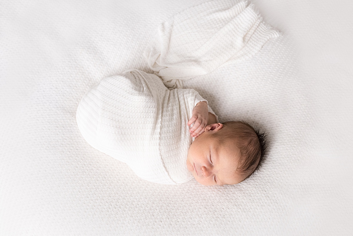 photography newborn sleeps wrapped in white