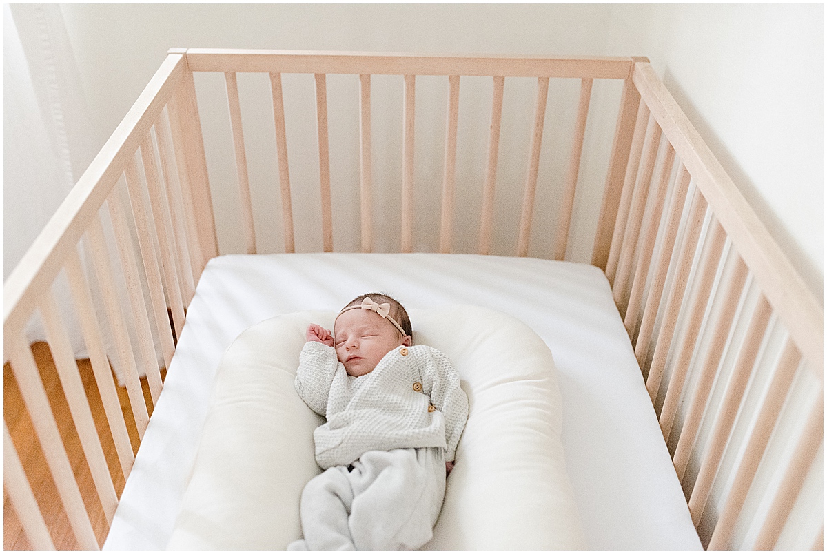 lifestyle newborn photography newborn girl sleeps in crib
