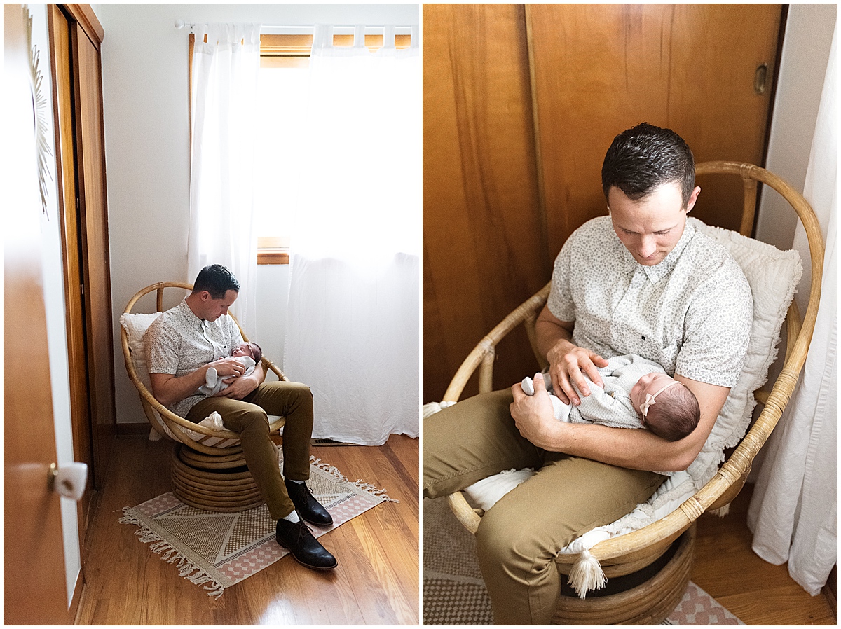 lifestyle newborn photography dad holds daughter in rocker in nursery 