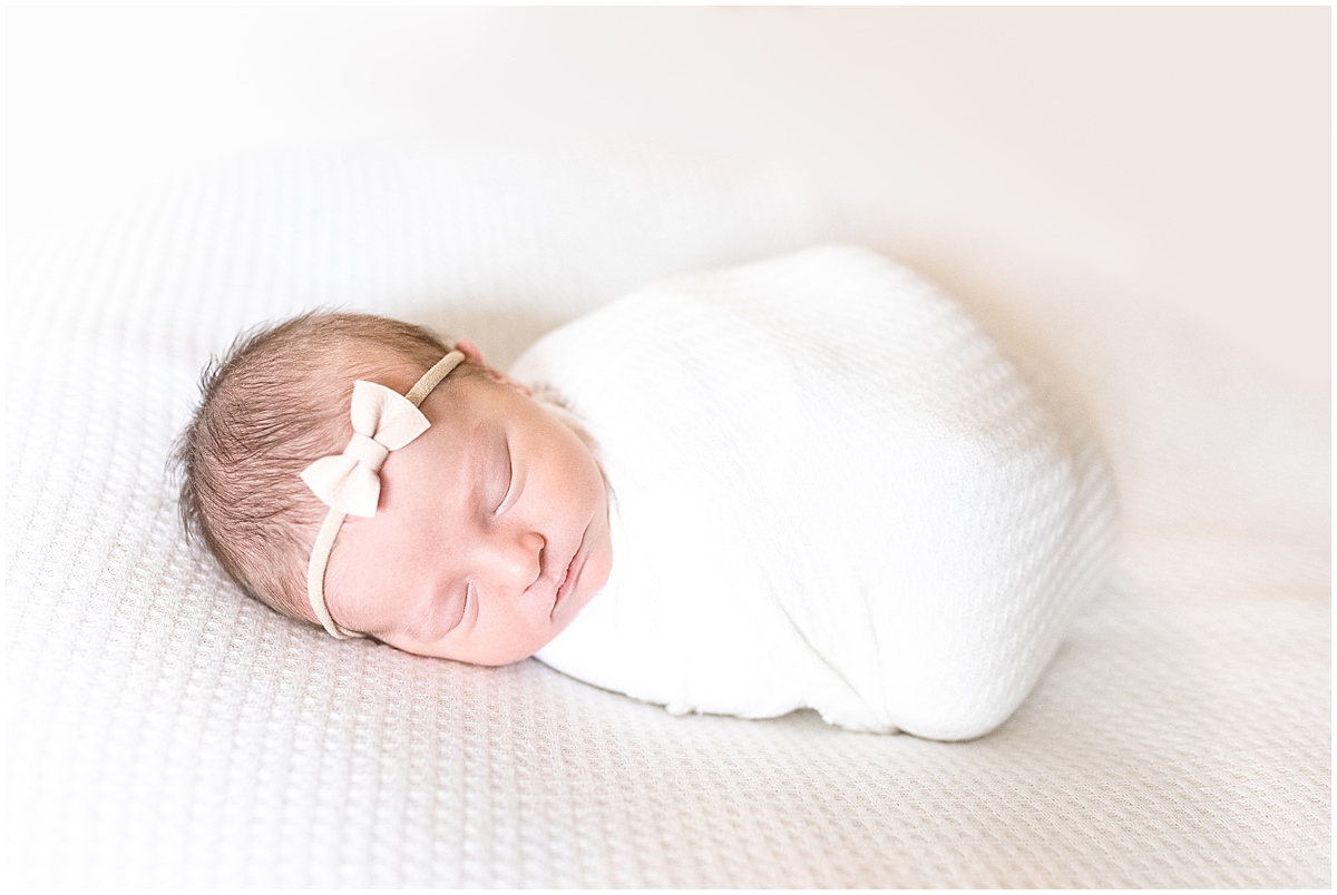 lifestyle newborn photography sleeping newborn girl wearing cream bow