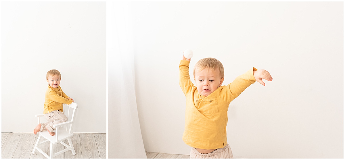 baby milestone photography in columbus ohio toddler boy throws ball in studio