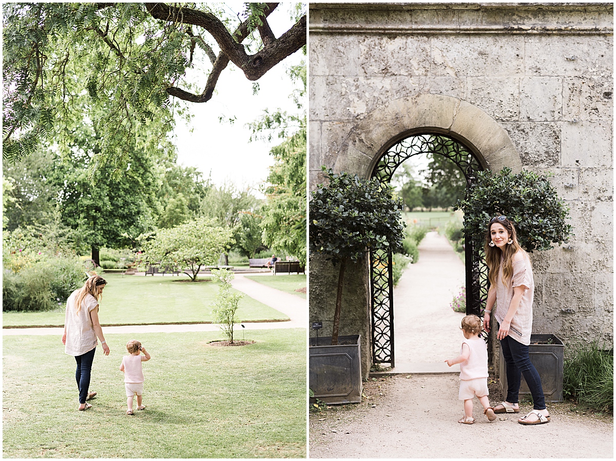 european travel photographer mom and daughter walk through botanical garden