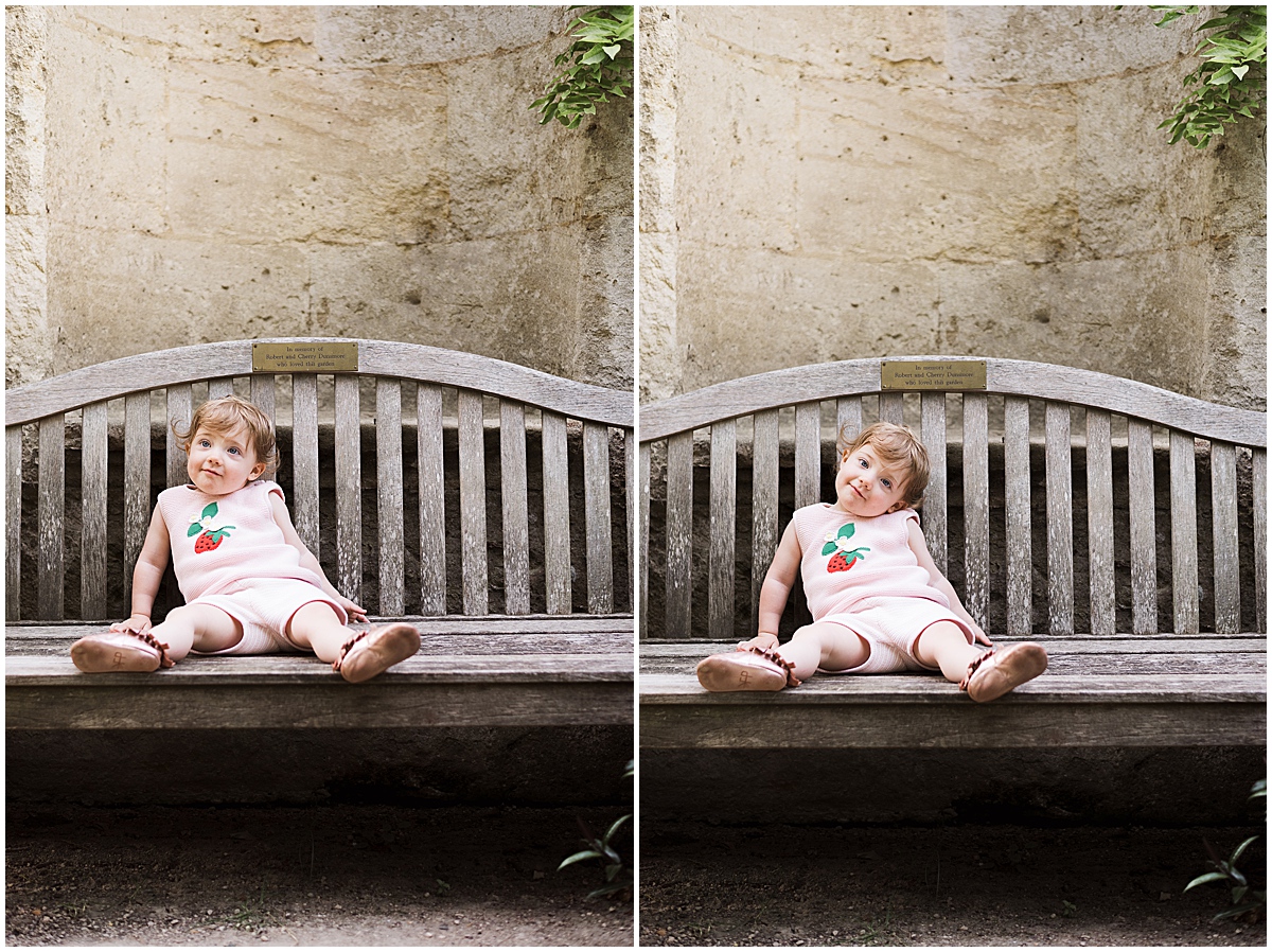 european travel photographer toddler girl sits on bench 