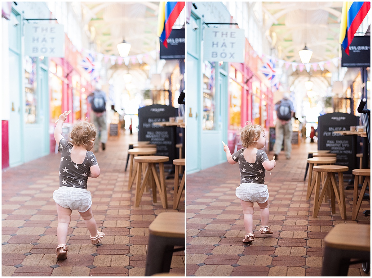 europe travel photographer toddler girl runs in covered market