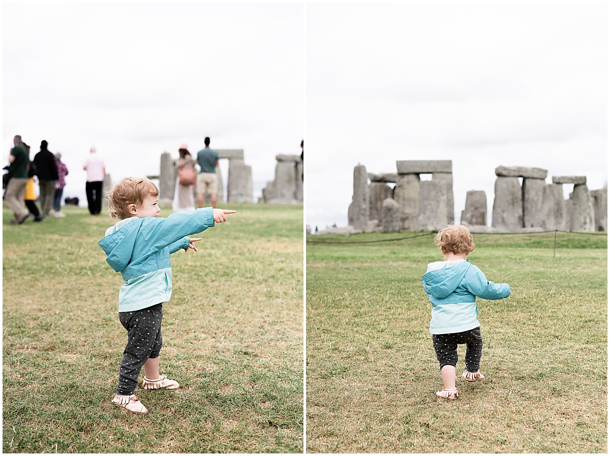 europe travel photographer toddler runs around grounds of stonehenge