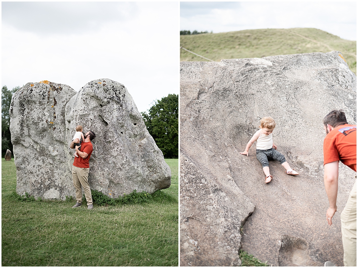 europe travel photographer toddler climbs on avebury stones