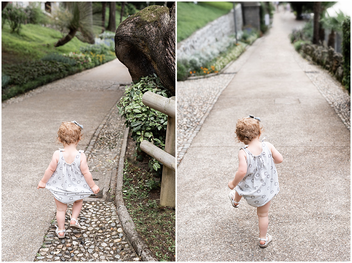 lifestyle travel photographer toddler walks funny walk at Villa Monastero