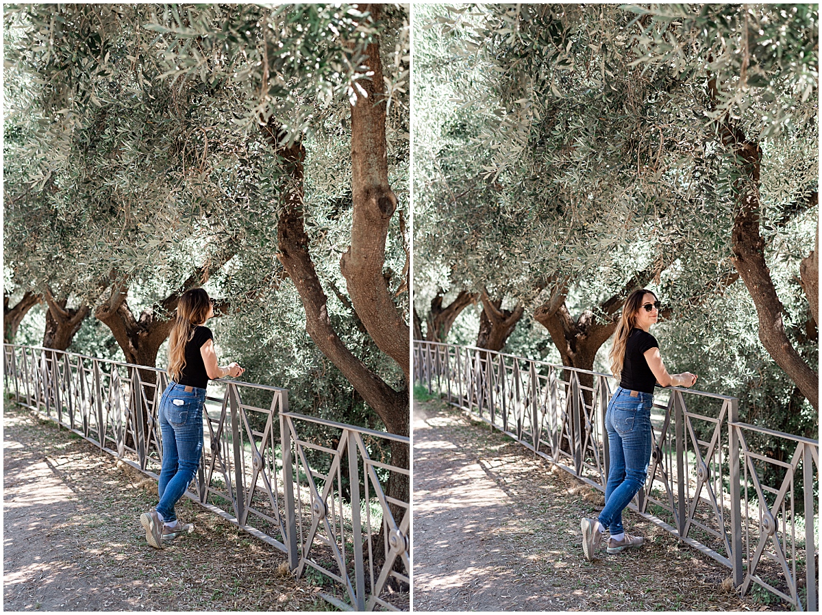 woman stands in jeans and black top next to olive trees