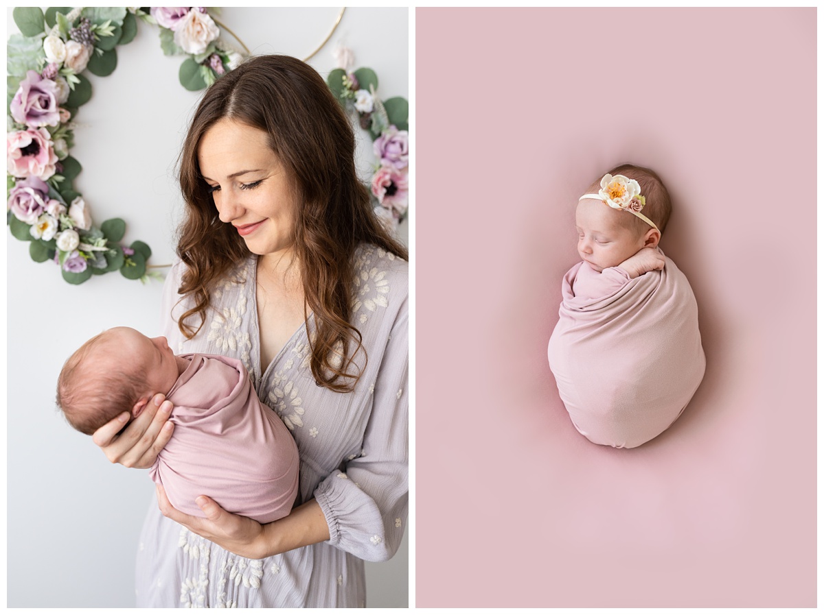 mom holds newborn daughter in studio with flowers and pink wrap
