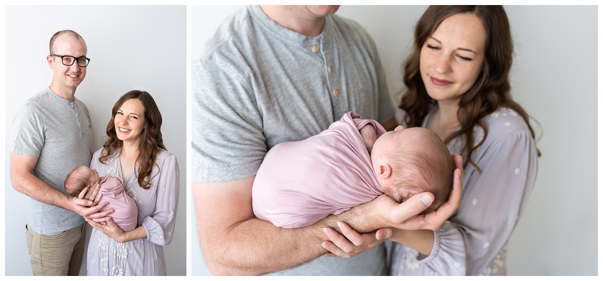 mom and dad hold their newborn daughter