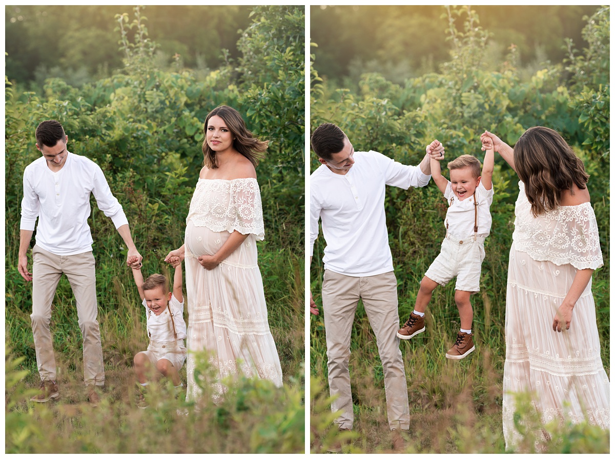 pregnant mom with dad and son play in the field dressed in neutral ivory