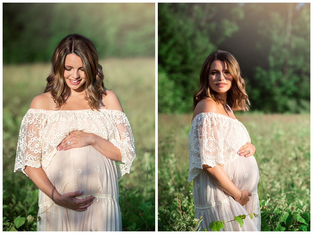 smiling mom looks at her pregnant belly in the field in boho gown
