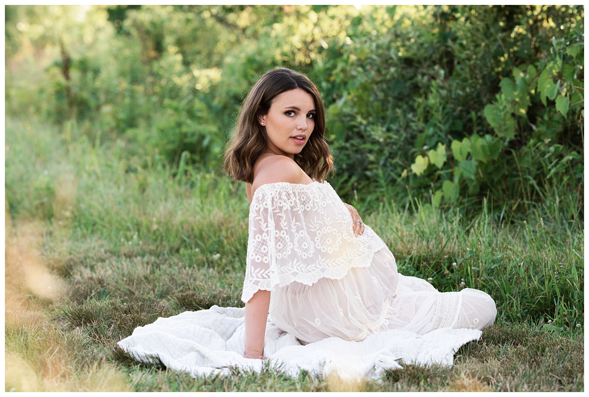 mom to be in ivory lace dress in green field