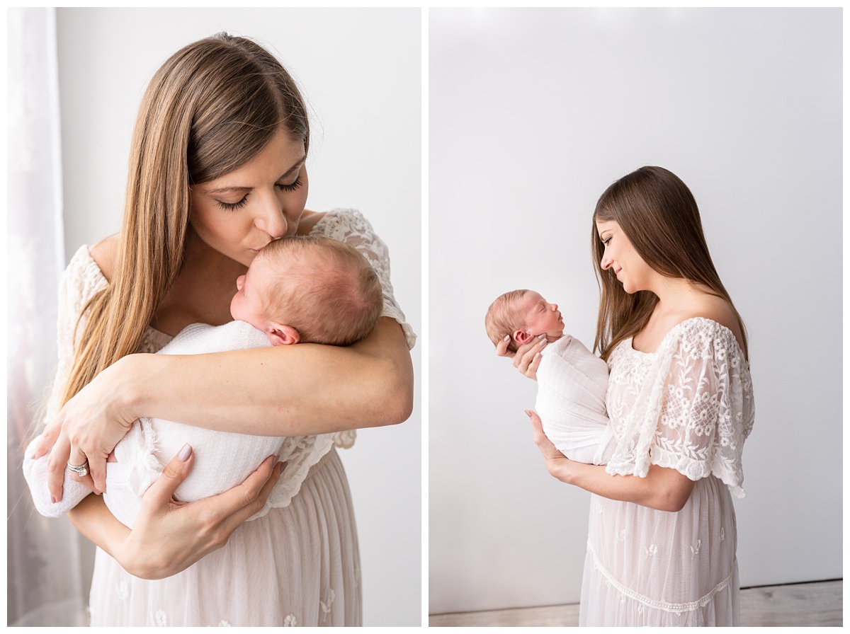 mom kisses newborn son in boho dress in studio newborn session columbus