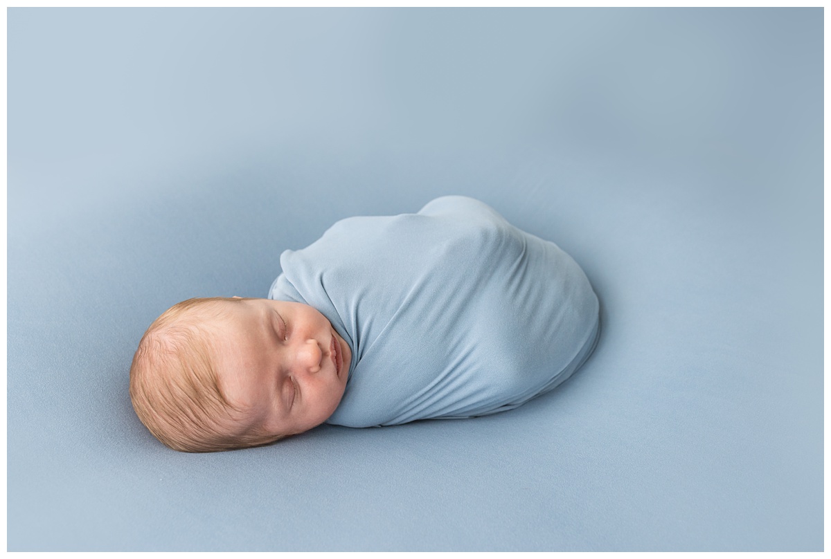 dusty blue studio newborn session columbus baby sleeps peacefully