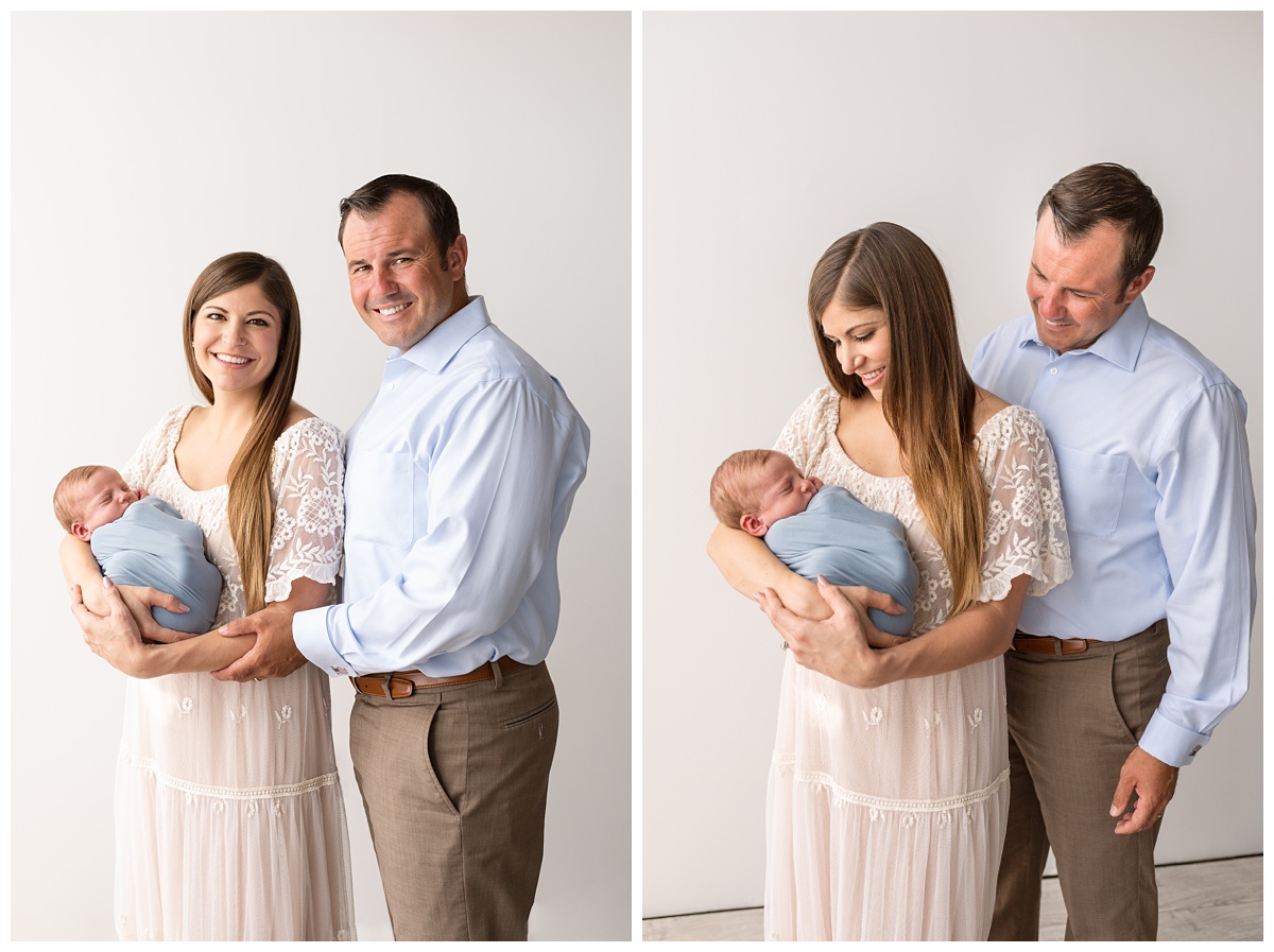 boy in dusty blue wrap with mom and dad studio newborn session columbus