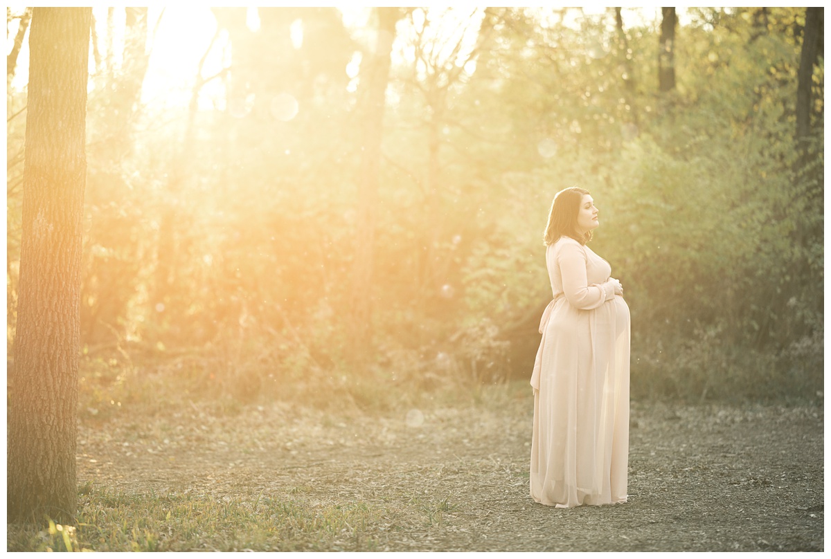 Top maternity Photographer Columbus Ohio pregnant mom stands in trail at sunset 