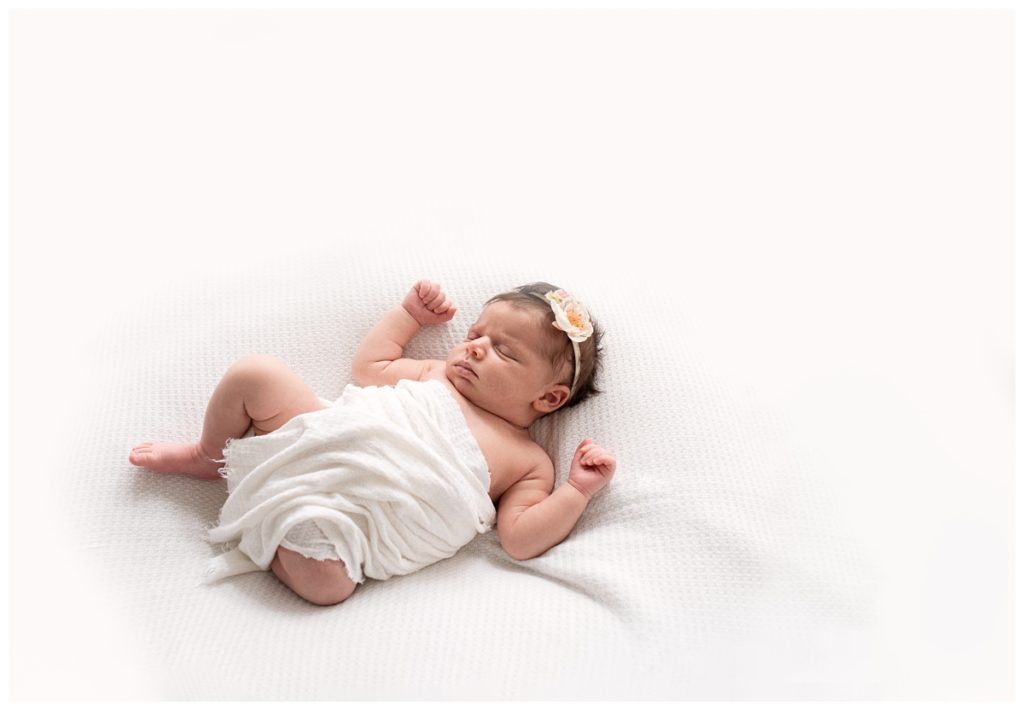 newborn photography columbus unposed baby girl sleeps in white blanket