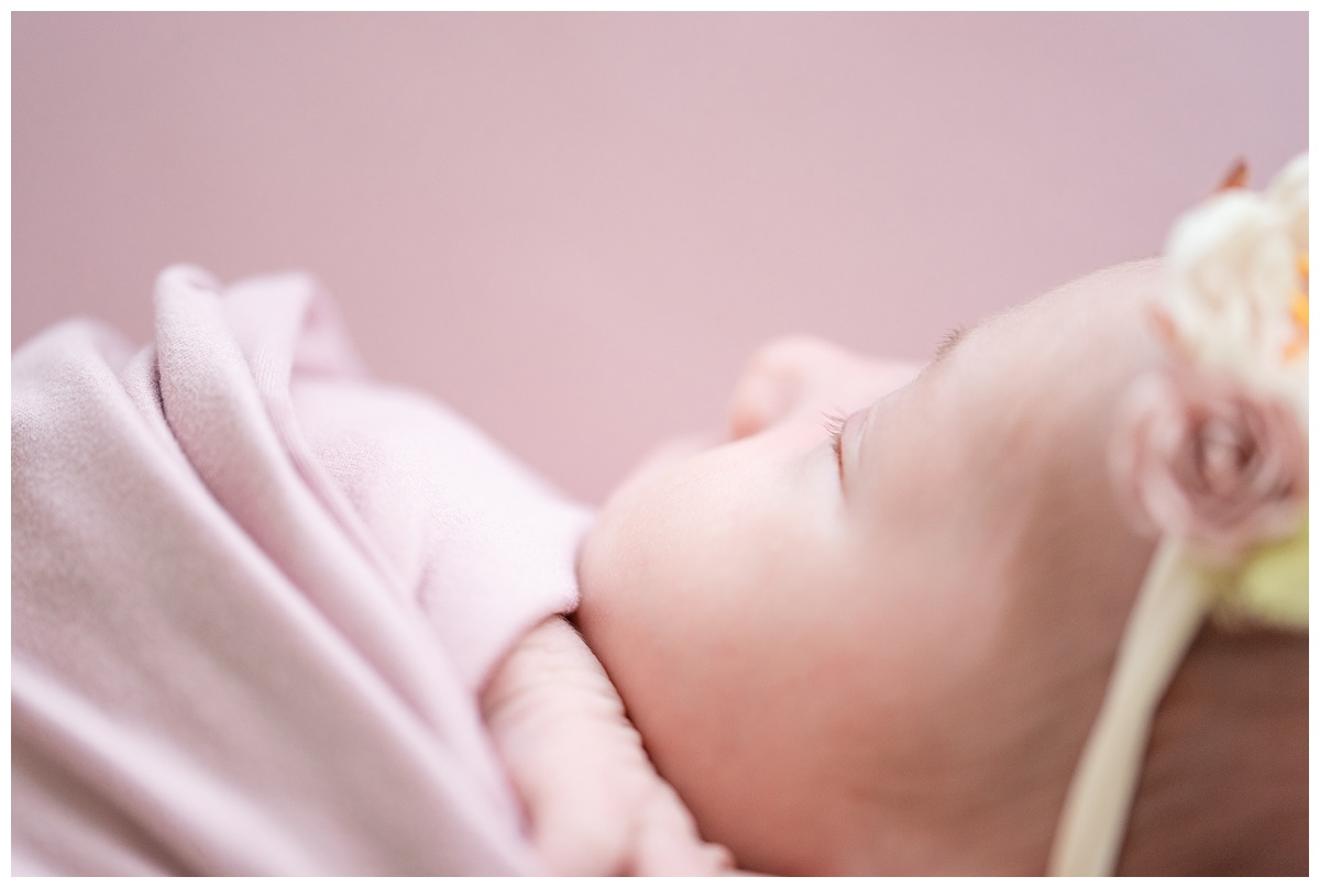 Top Newborn Photographer Columbus Ohio details of baby's eyelashes with pink background