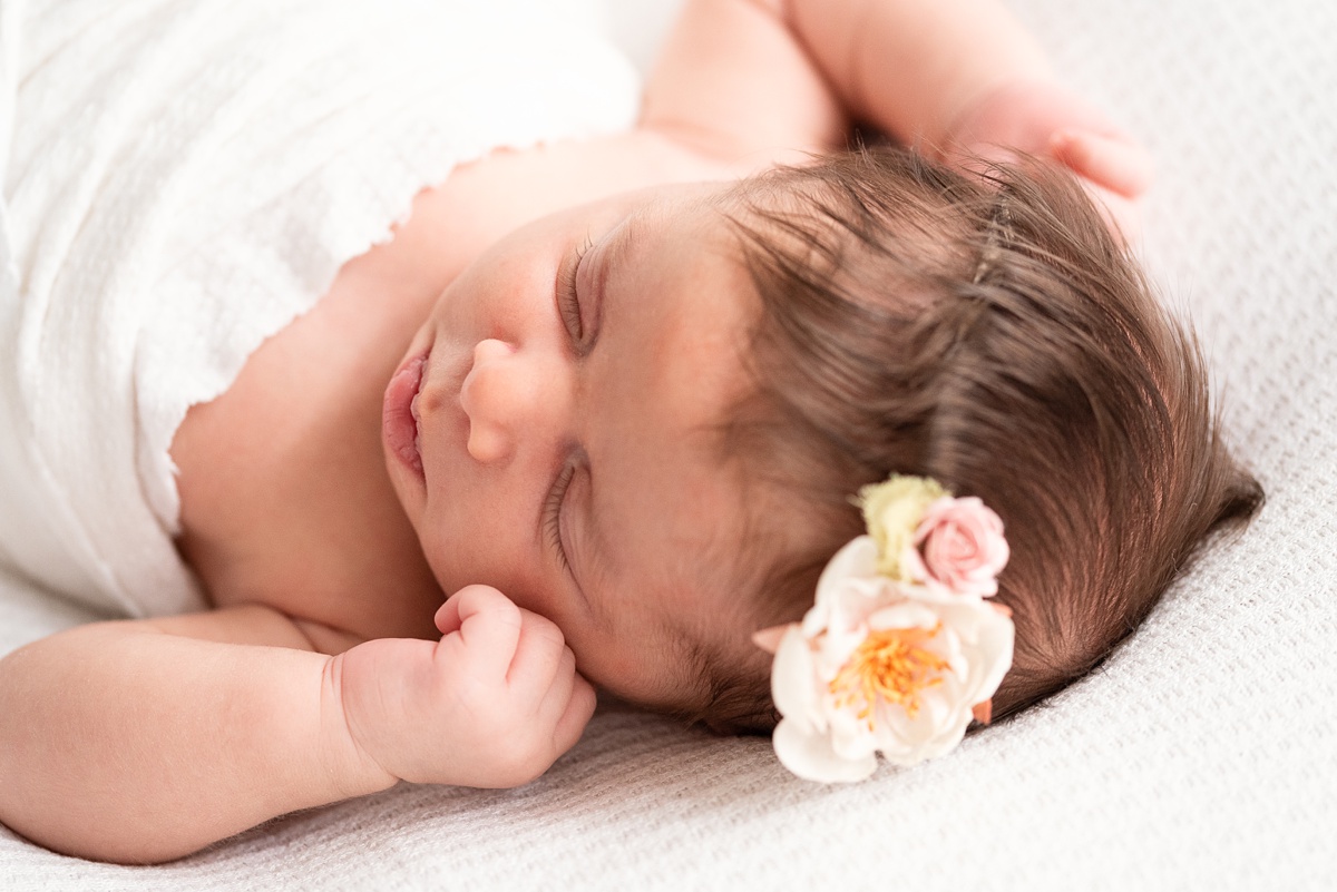 columbus ohio newborn photographer detail of newborn girl's face with flower headband