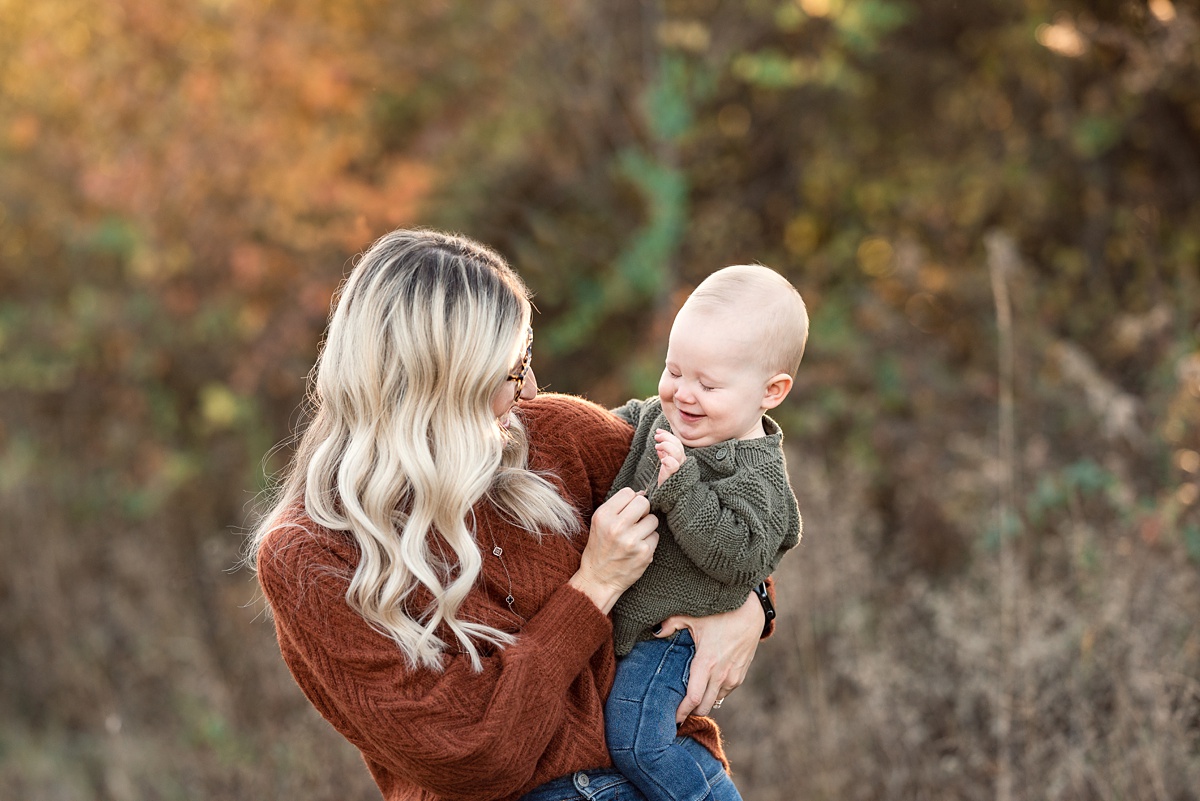 Top Family Photographers Columbus Ohio mom plays with toddler boy in field