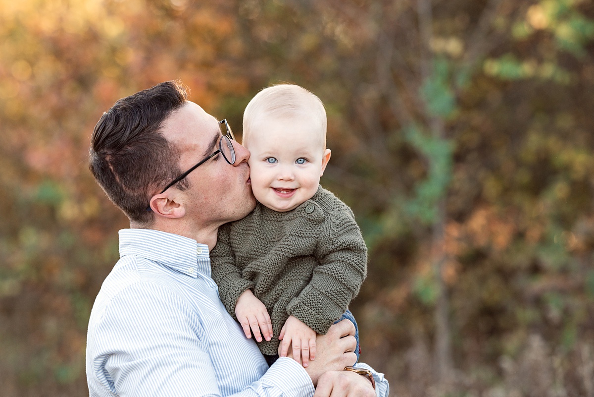 Top Family Photographers Columbus Ohio dad kisses toddler boy at sunset