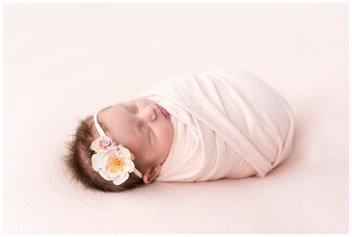 Lifestyle Newborn Photographer Columbus Ohio sleeping girl in pink with floral headband