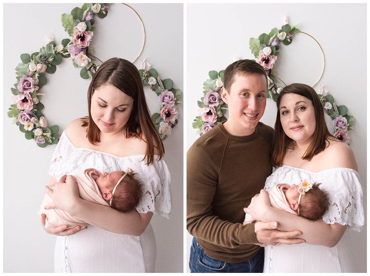 Lifestyle Newborn Photographer Columbus Ohio mom holds baby girl behind floral decorative background