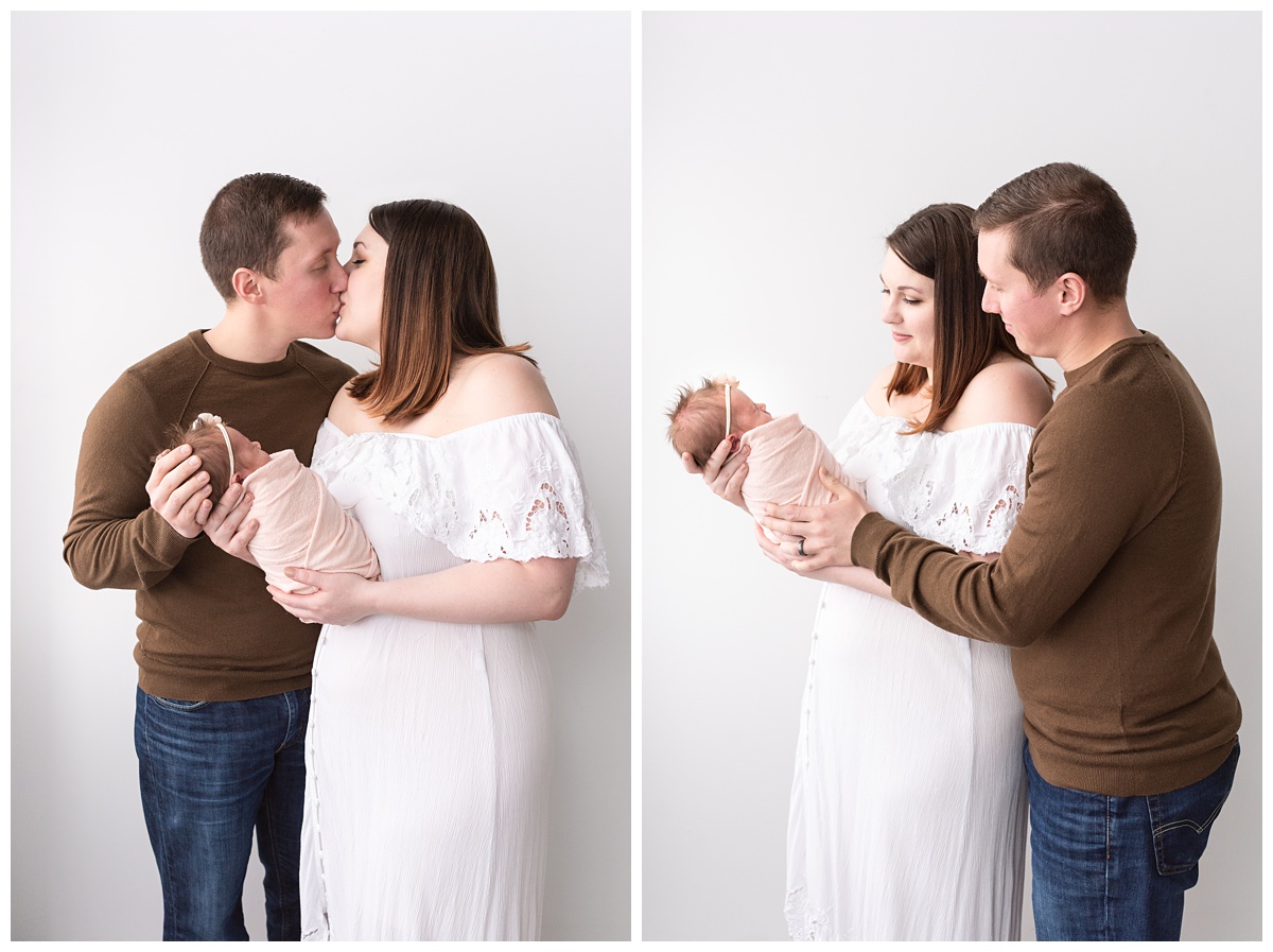 Lifestyle Newborn Photographer Columbus Ohio mom and dad kiss holding newborn 