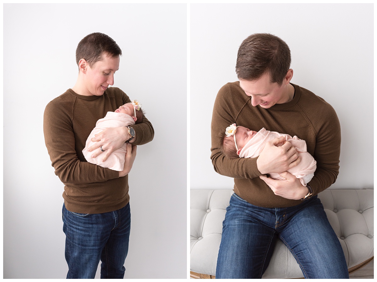 Lifestyle Newborn Photographer Columbus Ohio dad in brown shirt cradles newborn girl