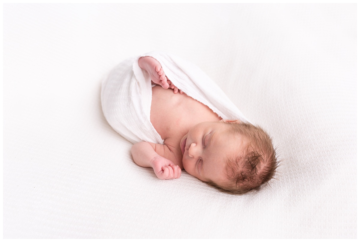 Lifestyle Newborn Photographer Columbus Ohio unposed newborn portrait in white