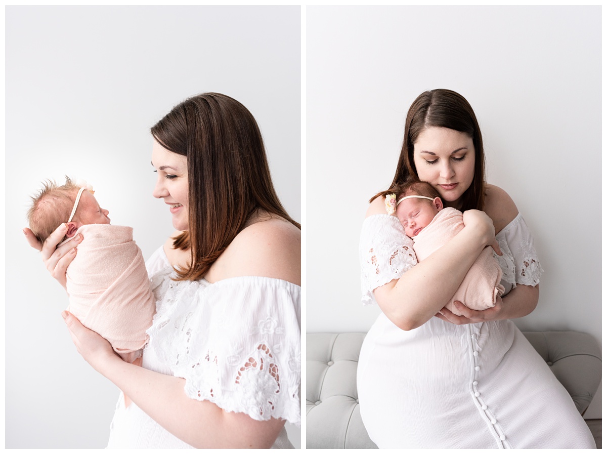 Lifestyle Newborn Photographer Columbus Ohio mom holds newborn girl in pink with white walls