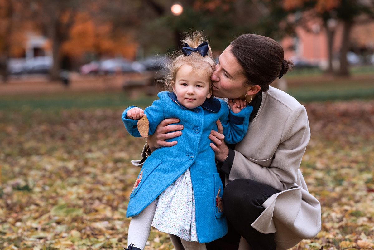 Lifestyle Family Photographer Columbus mom kisses toddler in boden coat
