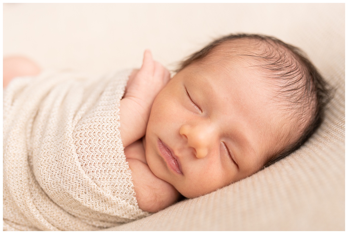 Best Columbus Newborn Photographer newborn boy sleeps with spit bubbles 