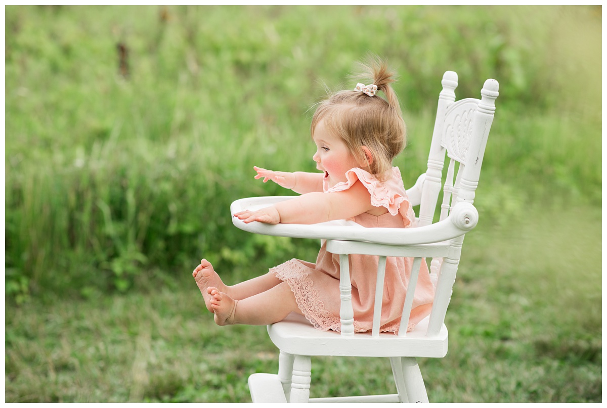 Family Photographers Columbus  profile of baby girl sitting in white highchair 